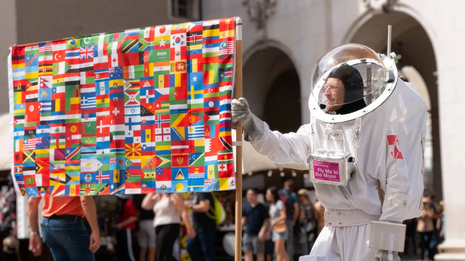 a man in a space suit holding a flag